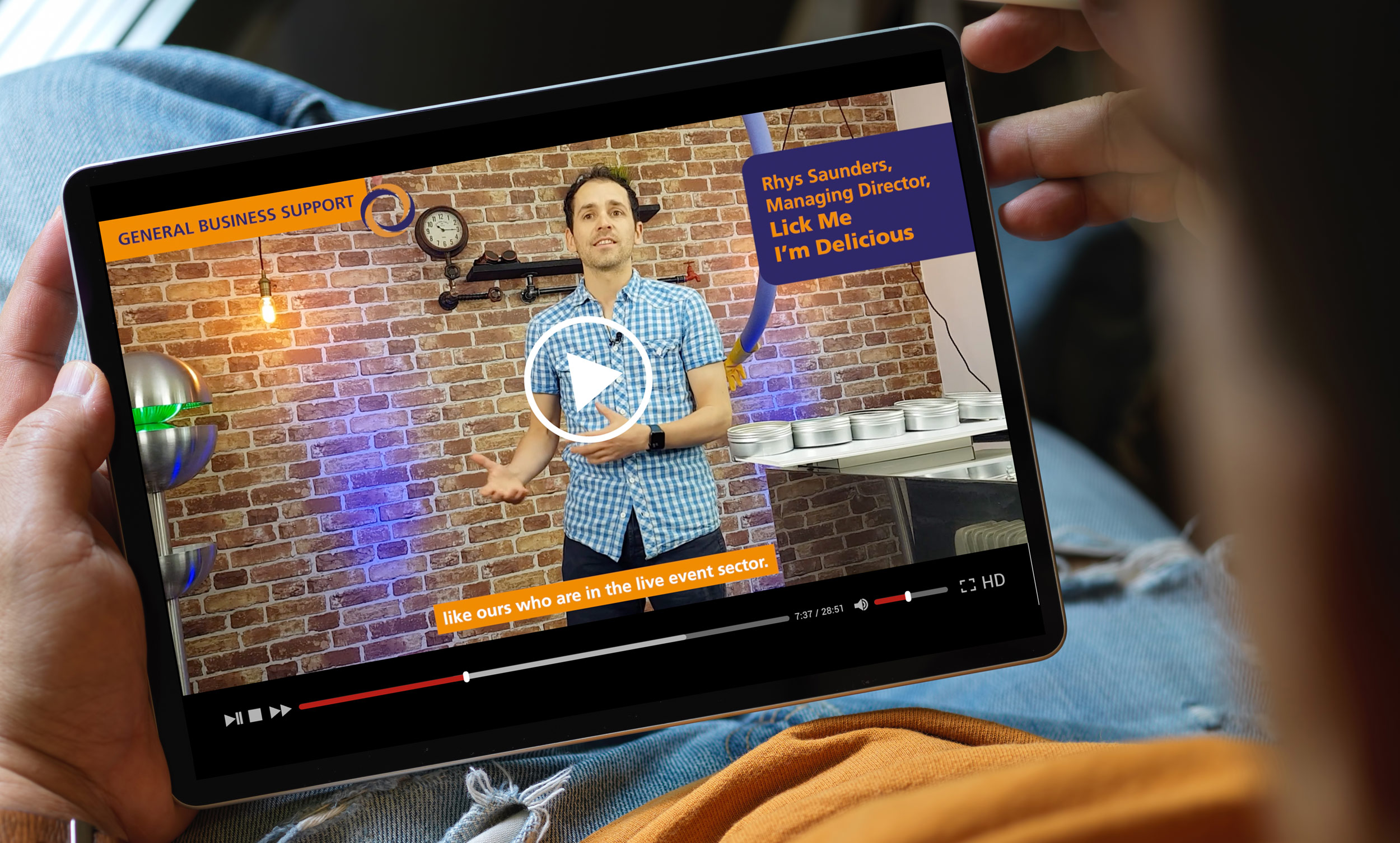 photo of ipad showing a video of business talking about business support